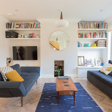 Bright living room with navy blue sodas and mustard yellow accent cushions