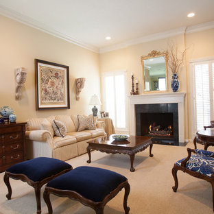 Inspiration for a large timeless formal and open concept medium tone wood floor living room remodel in Houston with beige walls, a standard fireplace and a tile fireplace