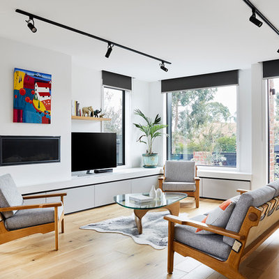 Mid-sized trendy open concept light wood floor and brown floor living room photo in Melbourne with a plaster fireplace, a tv stand, white walls and a ribbon fireplace