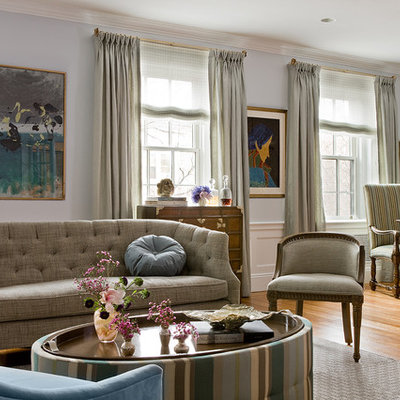 Trendy medium tone wood floor living room photo in Boston with blue walls