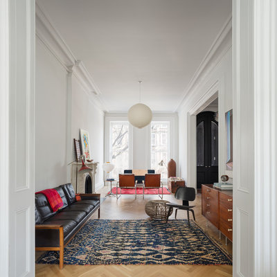 Living room - scandinavian enclosed medium tone wood floor living room idea in New York with white walls and a standard fireplace