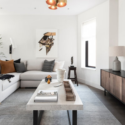 Trendy open concept dark wood floor and brown floor living room photo in New York with white walls and no fireplace