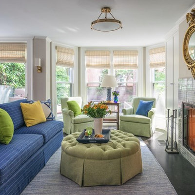 Example of a classic open concept black floor living room design in Boston with beige walls, a standard fireplace and a tile fireplace