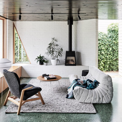 Mid-sized trendy open concept concrete floor and green floor living room photo in Melbourne with a wood stove, a metal fireplace and white walls
