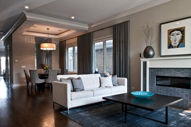 Mid-sized minimalist open concept dark wood floor living room photo in Chicago with gray walls, a standard fireplace and a tile fireplace