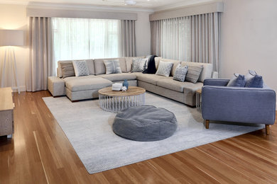 Medium sized contemporary open plan living room in Sunshine Coast with grey walls, medium hardwood flooring and brown floors.