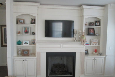 Foto de salón abierto tradicional de tamaño medio con paredes blancas, moqueta, todas las chimeneas, marco de chimenea de yeso, televisor colgado en la pared y suelo beige