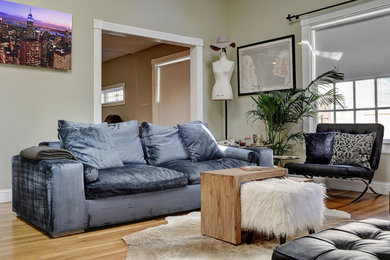 Inspiration for a mid-sized contemporary enclosed medium tone wood floor living room remodel in Austin with beige walls