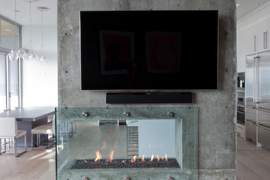 Trendy living room photo in Vancouver with a two-sided fireplace