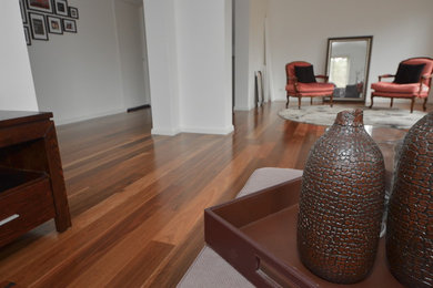 Example of a small transitional enclosed living room design in Sydney with white walls and no tv