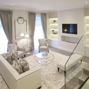 Classic living room in London with white walls, light hardwood flooring, a ribbon fireplace, a wall mounted tv and grey floors.