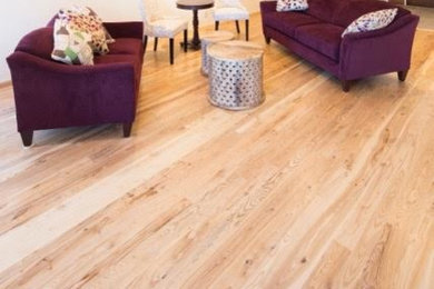 Elegant medium tone wood floor living room photo in Other