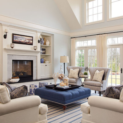 Inspiration for a large coastal enclosed dark wood floor living room remodel in Portland with blue walls, a standard fireplace and a stone fireplace