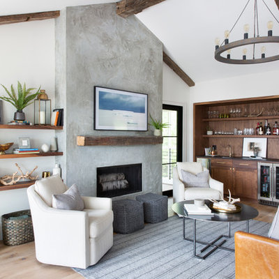 Living room - mid-sized transitional medium tone wood floor and brown floor living room idea in Austin with white walls, a standard fireplace, a concrete fireplace and a wall-mounted tv