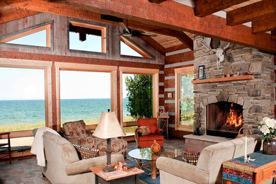 Example of a large mountain style open concept and formal slate floor living room design in Other with brown walls, a standard fireplace, a stone fireplace and no tv