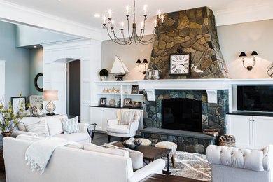 Inspiration for a huge timeless formal and open concept dark wood floor and brown floor living room remodel in Seattle with beige walls, a standard fireplace, a stone fireplace and a wall-mounted tv
