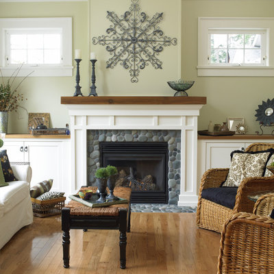 Inspiration for a timeless medium tone wood floor living room remodel in Vancouver with beige walls and a standard fireplace