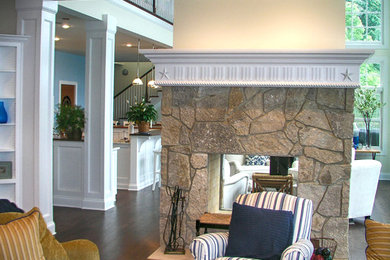 Living room - coastal dark wood floor living room idea in Other with a two-sided fireplace and a stone fireplace