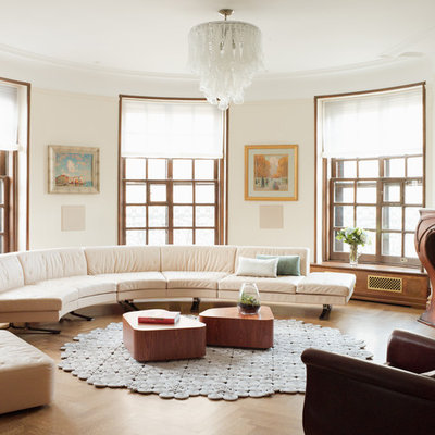 Mid-sized transitional formal and open concept medium tone wood floor living room photo in New York with beige walls, a standard fireplace, no tv and a wood fireplace surround