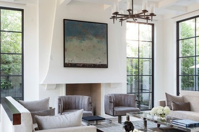 Example of a large minimalist formal and open concept limestone floor living room design in Dallas with white walls, a plaster fireplace, no tv and a standard fireplace