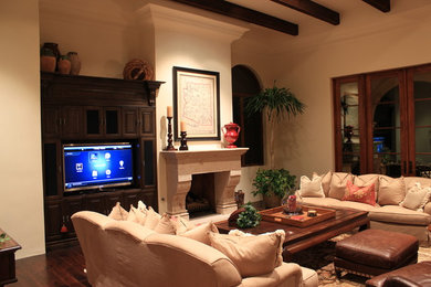 Medium sized classic formal enclosed living room in Phoenix with beige walls, dark hardwood flooring, a standard fireplace, a plastered fireplace surround and a freestanding tv.