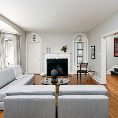 Inspiration for a timeless brown floor living room remodel in DC Metro with a standard fireplace, no tv and gray walls