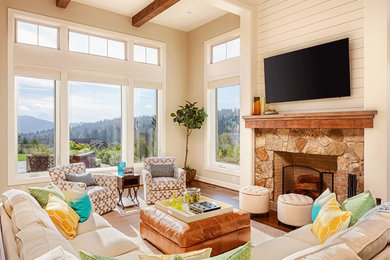 Country dark wood floor and brown floor living room photo in Austin with beige walls, a standard fireplace and a stone fireplace