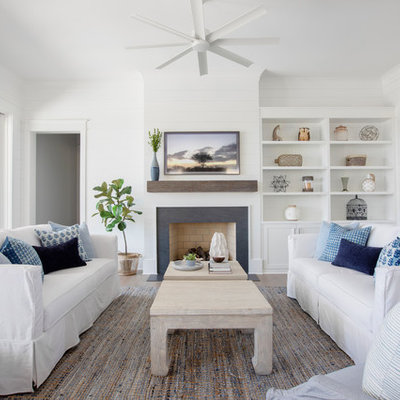 Inspiration for a coastal living room remodel in Charleston with white walls and a standard fireplace