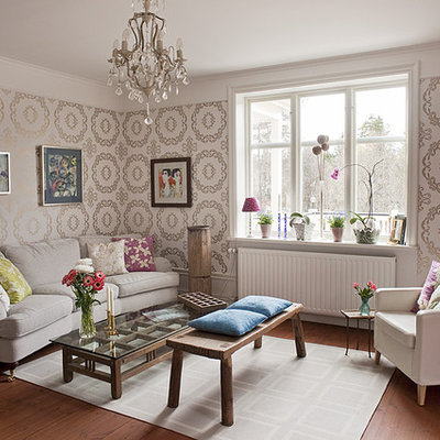 Inspiration for a mid-sized eclectic formal and enclosed medium tone wood floor living room remodel in Stockholm with beige walls, no fireplace and no tv