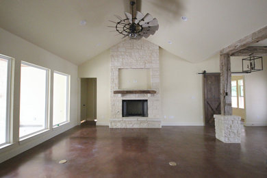 Living room - country concrete floor living room idea in Austin with a standard fireplace and a stone fireplace
