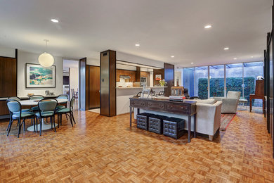 Example of a large mid-century modern open concept medium tone wood floor and brown floor living room design in Houston with white walls, no fireplace, a media wall and a music area