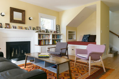 Example of a mid-sized arts and crafts enclosed medium tone wood floor and brown floor living room design in San Francisco with yellow walls, a standard fireplace, a brick fireplace and no tv