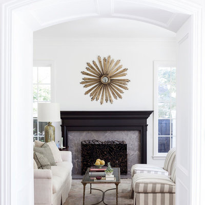 Example of a transitional formal living room design in Dallas with white walls and a standard fireplace