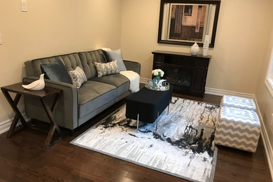 Example of a small minimalist formal and open concept dark wood floor and brown floor living room design in Toronto with beige walls, no fireplace and no tv