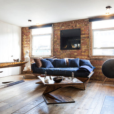 Living room - small industrial medium tone wood floor and brown floor living room idea in London with brown walls