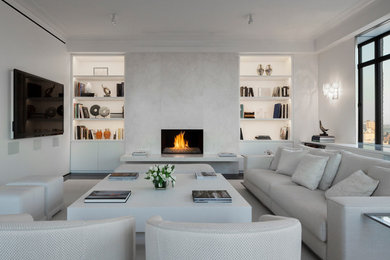 Large trendy open concept and formal dark wood floor living room photo in New York with white walls, a standard fireplace, a stone fireplace and a media wall