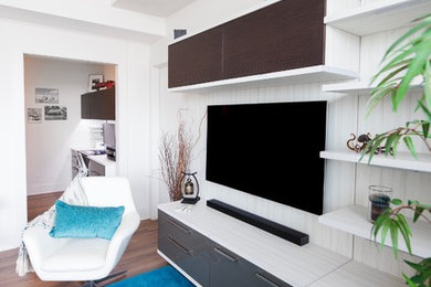 Small modern living room in Calgary with white walls and a built-in media unit.
