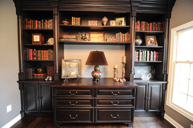 Mid-sized elegant enclosed dark wood floor living room library photo in Cleveland with gray walls