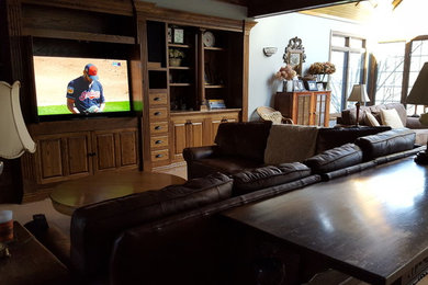 Example of a large classic formal and open concept carpeted and beige floor living room design in Cleveland with gray walls, no fireplace and a media wall
