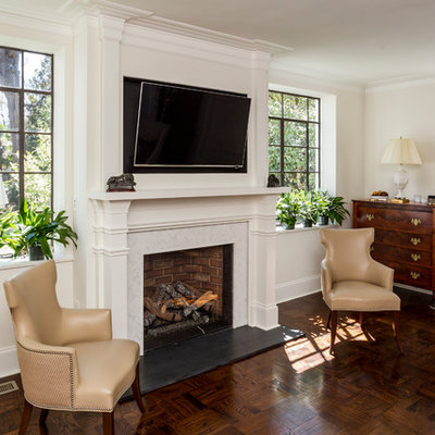 Living room - mid-sized transitional formal and enclosed dark wood floor and brown floor living room idea in Charlotte with a standard fireplace, a tile fireplace, a wall-mounted tv and gray walls