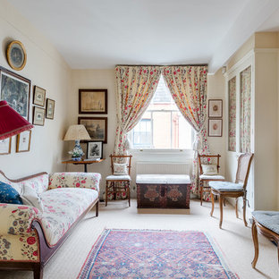 This is an example of a medium sized victorian formal enclosed living room in London with beige walls, carpet, no tv, beige floors and a standard fireplace.