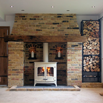Charnwood island 3b wood boiler stove with reclaimed brick and oak fireplace