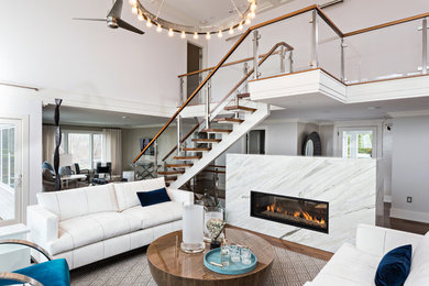 Example of a large trendy open concept medium tone wood floor and brown floor living room design in Boston with a ribbon fireplace, no tv, white walls and a tile fireplace