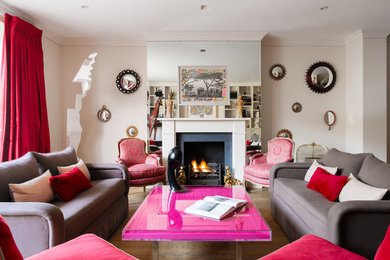 This is an example of a contemporary formal living room in London with medium hardwood flooring, a standard fireplace and no tv.