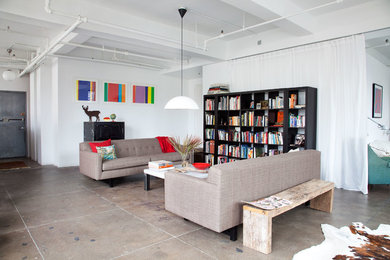 Example of an urban concrete floor living room design in New York