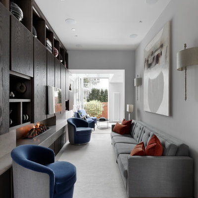 Mid-sized trendy beige floor living room photo in London with white walls, a concrete fireplace and a wall-mounted tv