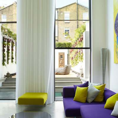 Inspiration for a huge contemporary open concept concrete floor and gray floor living room remodel in London with white walls