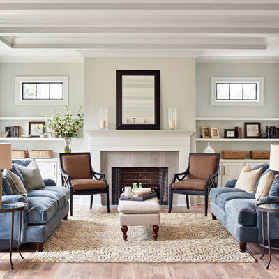 Inspiration for a transitional formal light wood floor living room remodel in Charlotte with gray walls, a standard fireplace and no tv
