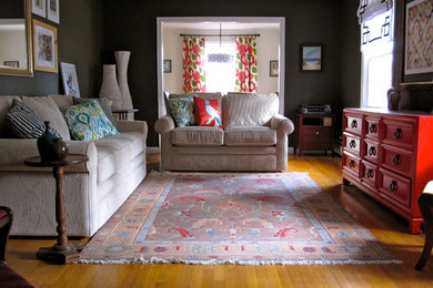 Example of a mid-sized transitional enclosed medium tone wood floor living room design in Richmond with gray walls, no fireplace and no tv