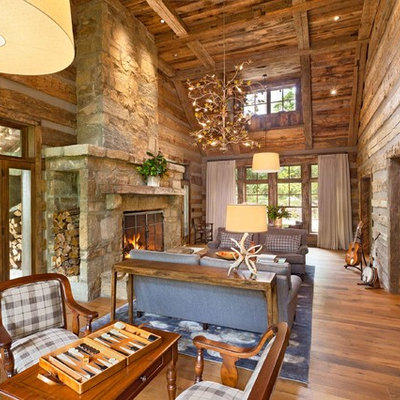 Mountain style living room photo in Other with a music area, a standard fireplace, a stone fireplace and no tv